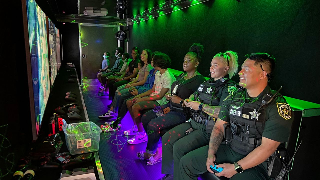 Deputies sat with young people Saturday morning, to rollout the new video gaming center they will soon take to Orange County neighborhoods. (Spectrum News 13/Ashleigh Mills)