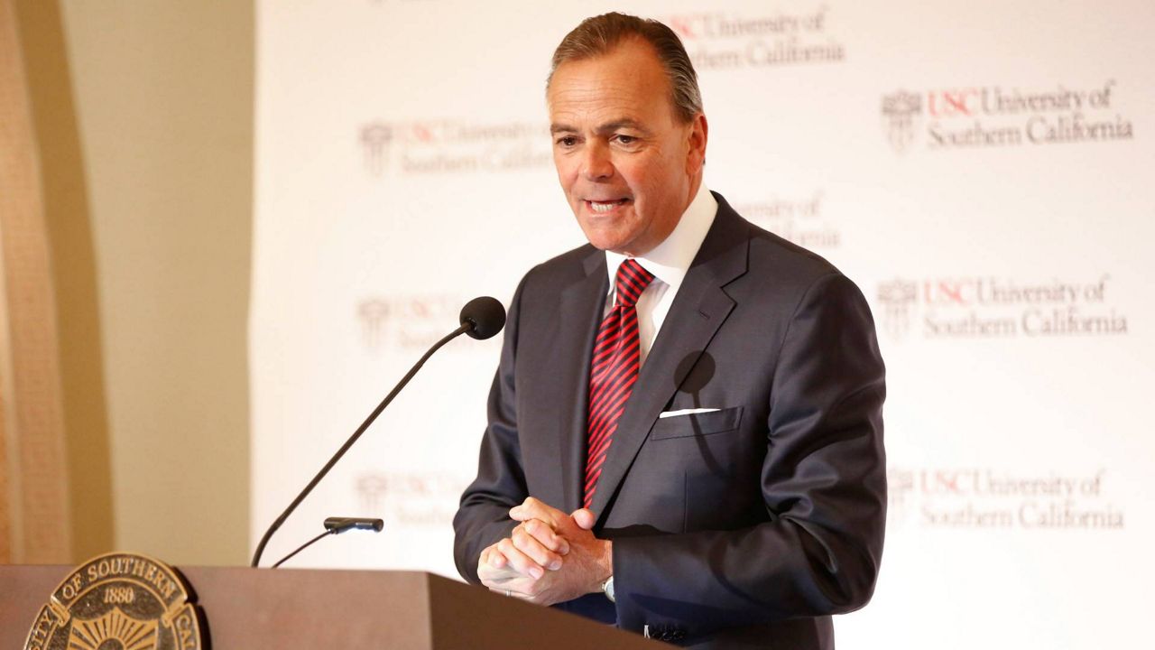 Rick Caruso, chairman of the University of Southern California Board of Trustees announces Carol Folt as the USC's 12th president in Los Angeles, March 20, 2019. (AP Photo/Damian Dovarganes)