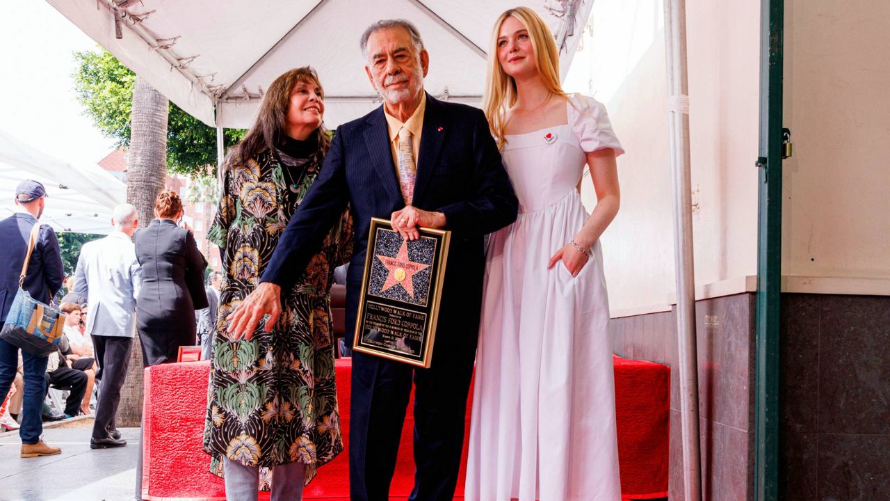 Talia Shire, from left, Francis Ford Coppola and Elle Fanning pose with a star miniature following a ceremony honoring Coppola with a star on the Hollywood Walk of Fame on March 21, 2022, in Los Angeles. (Photo by Willy Sanjuan/Invision/AP)