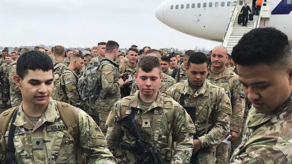 Soldiers from the 1st Armored Division, based in Fort Bliss, Texas, arrives at the airport Tegel in Berlin, Thursday, March 21, 2019. Over three hundred soldiers have arrived in Germany from their base in Texas in the first test of a new American strategy to rapidly deploy troops based in the United States to Europe to bolster the NATO deterrent against possible Russian aggression. (AP Photo/Dorothee Thiesing)