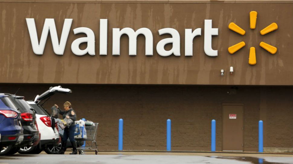 A shopper loads her car after shopping at a Walmart in Pittsburgh, Thursday, Feb. 22, 2018. (AP Photo/Gene J. Puskar)