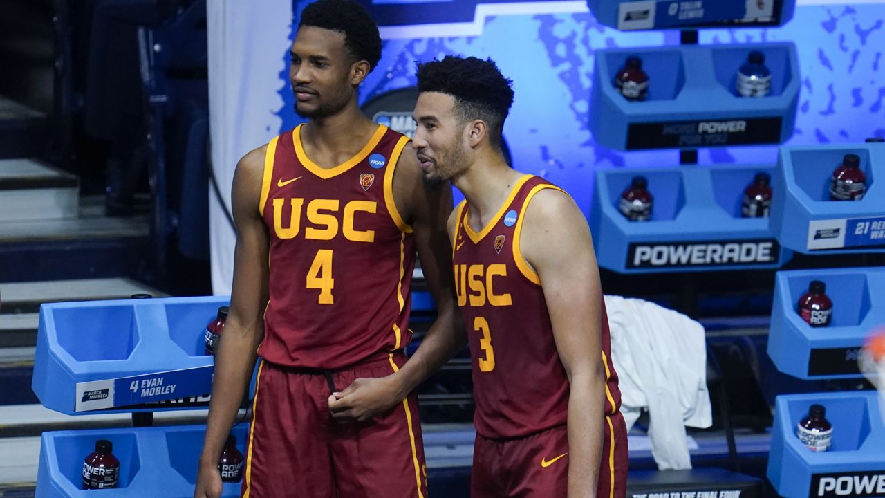 USC forward Evan Mobley (4) and USC forward Isaiah Mobley (3) watch from the bench during the second half of a men's college basketball game against Kansas in the second round of the NCAA tournament at Hinkle Fieldhouse in Indianapolis, Monday, March 22, 2021. (AP Photo/Paul Sancya)