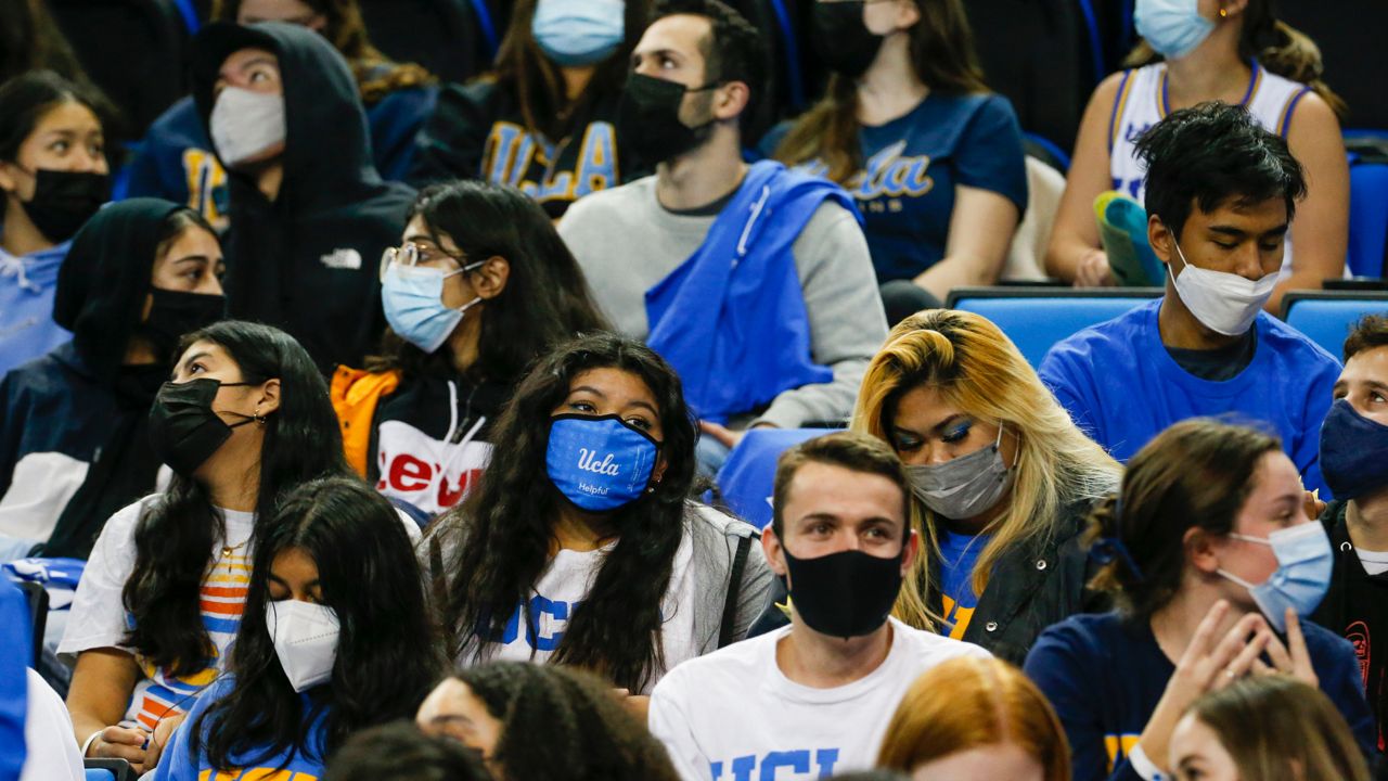 Fans wearing face masks at an NCAA college basketball game between Washington State and UCLA on Feb. 17, 2022, in Los Angeles. (AP Photo/Ringo H.W. Chiu)