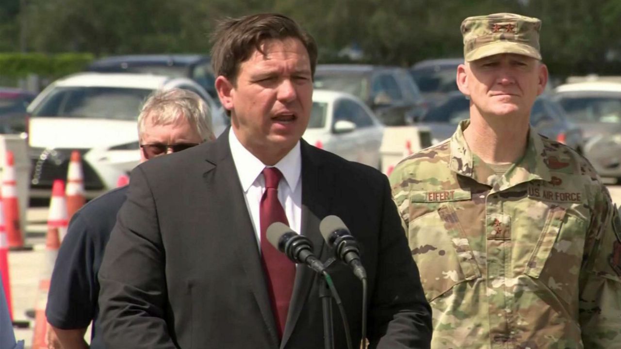 Florida Gov. Ron DeSantis speaks Sunday from the site of a drive-thru coronavirus testing site in Miami operated by the National Guard, which is set to open Monday. A similar site is set to open later this week in Central Florida. (Spectrum News)