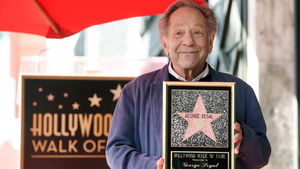Actor George Segal poses with a replica of his new star during a ceremony on the Hollywood Walk of Fame on Tuesday, Feb. 14, 2017, in Los Angeles. (Photo by Chris Pizzello/Invision/AP)