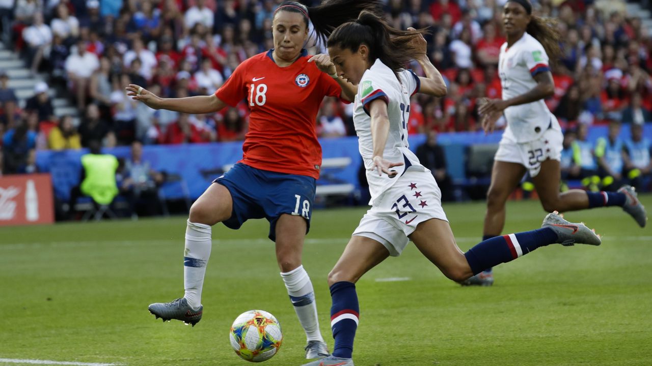 United States' Christen Press, right, shoots the ball next to Chile's Camila Saez during the Women's World Cup Group F soccer match between United States and Chile at Parc des Princes in Paris, France, Sunday, June 16, 2019. (AP Photo/Alessandra Tarantino)