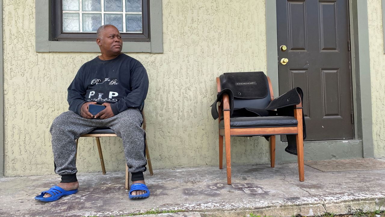 Brennen Hill sits outside the Parramore duplex he rents. (Molly Duerig, Spectrum News)