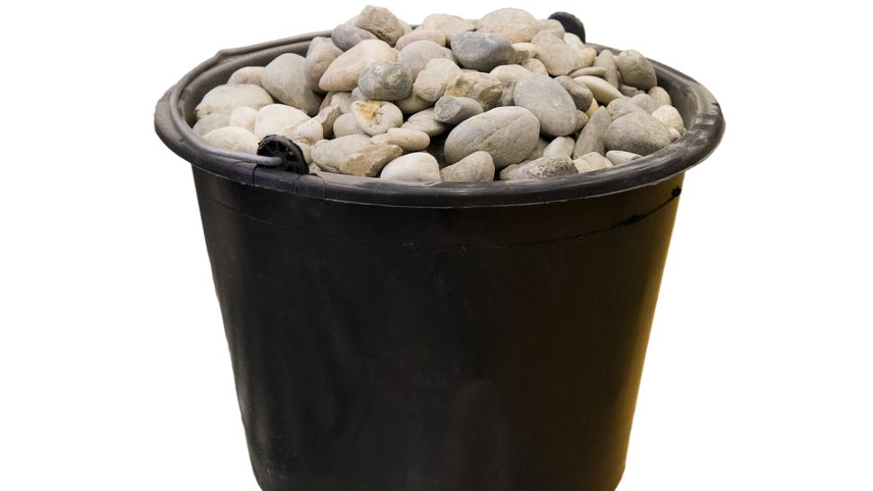 FILE- Bucket of stones.