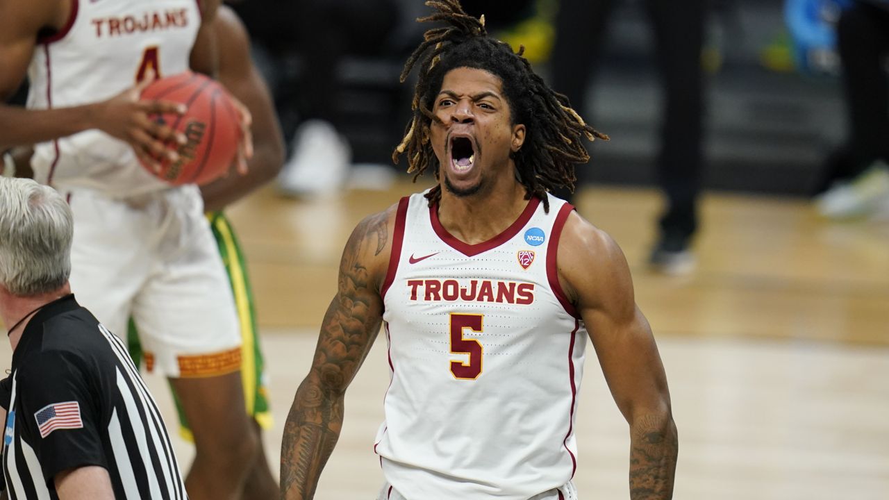 Southern California guard Isaiah White celebrates after making a basket during the first half of a Sweet 16 game against Oregon in the NCAA men's college basketball tournament at Bankers Life Fieldhouse, Sunday, March 28, 2021, in Indianapolis. (AP Photo/Jeff Roberson)
