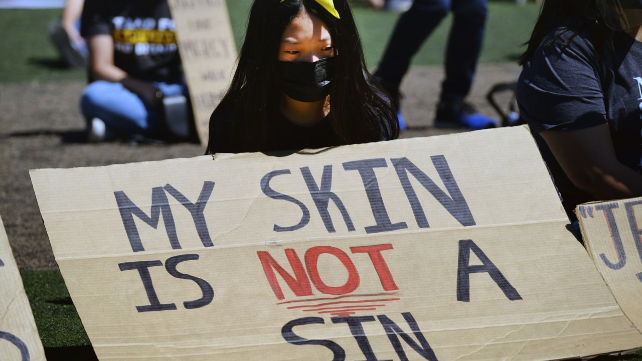 A demonstrator joins a rally against Asian hate, standing for Asian American and Pacific Islander dignity and lives in the Koreatown section of Los Angels on Sunday, March 28, 2021. (AP Photo/Richard Vogel)