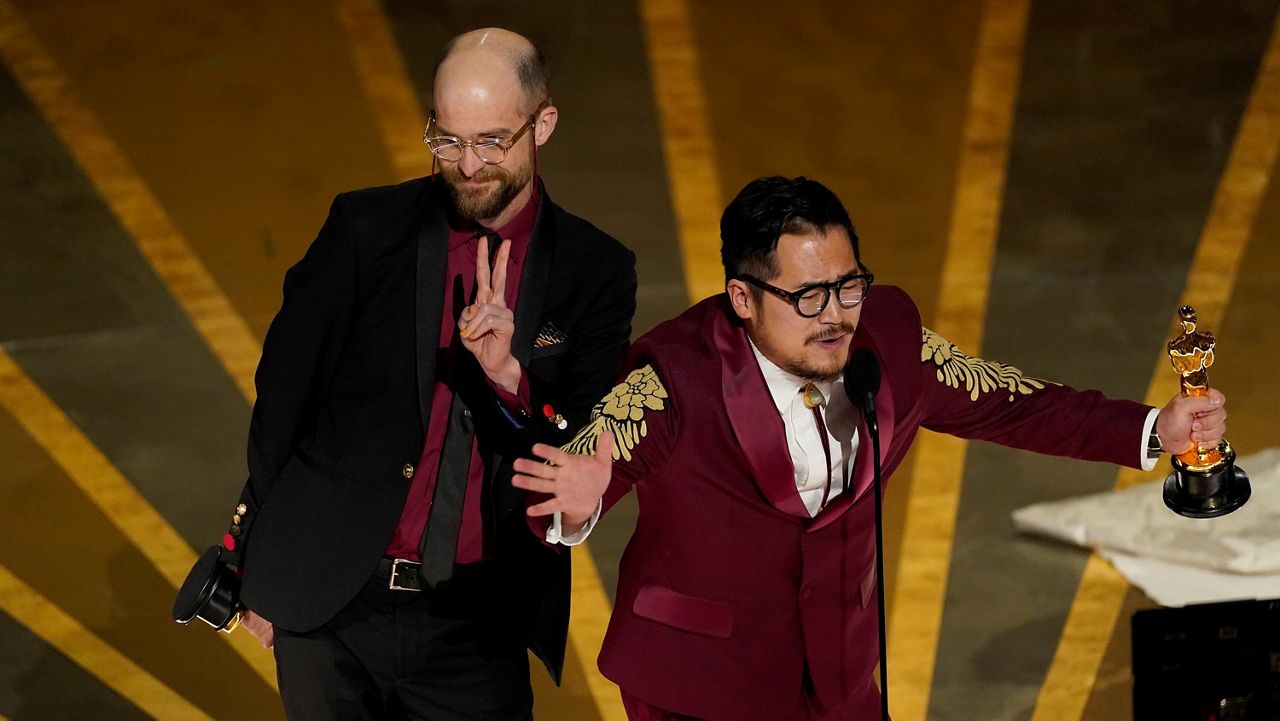 Daniel Scheinert (left) and Daniel Kwan (right) accept their Oscars for best director. (AP photo)