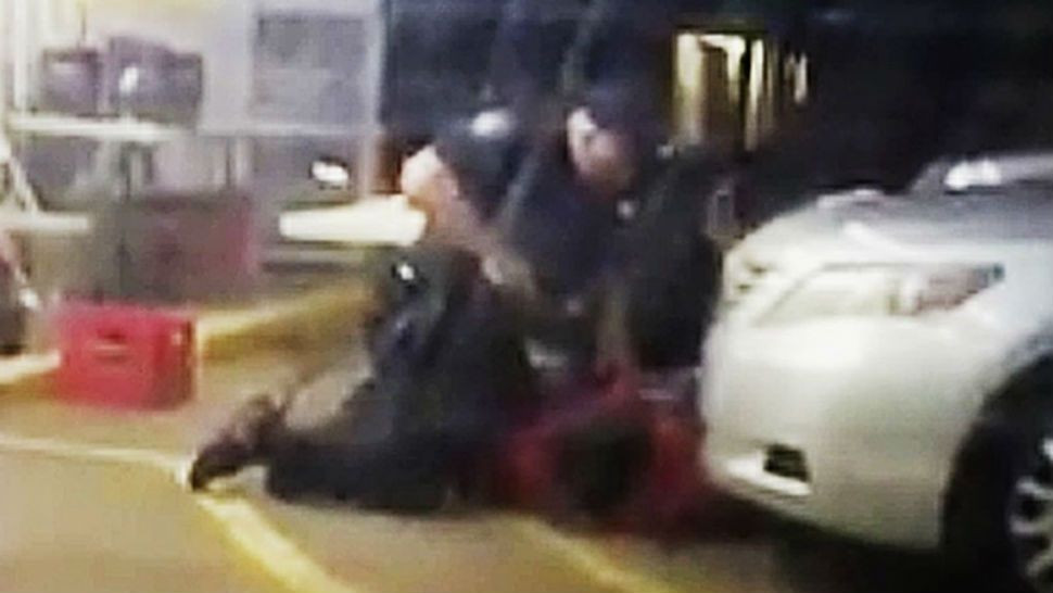 File - In this July 5, 2016 image made from video provided by Arthur Reed, Alton Sterling is restrained by two Baton Rouge police officers, one holding a gun, outside a convenience store in Baton Rouge, La. Moments later, one of the officers shot and killed Sterling, a black man who has been selling CDs outside the store, while he was on the ground. The investigation of the deadly police shooting that inflamed racial tensions in Louisiana's capital city has ended without criminal charges against two white officers who confronted Sterling. Experts in police tactics think the bloodshed could have been avoided if the Baton Rouge officers had done more to defuse the encounter with Sterling. (Arthur Reed via AP,File) 