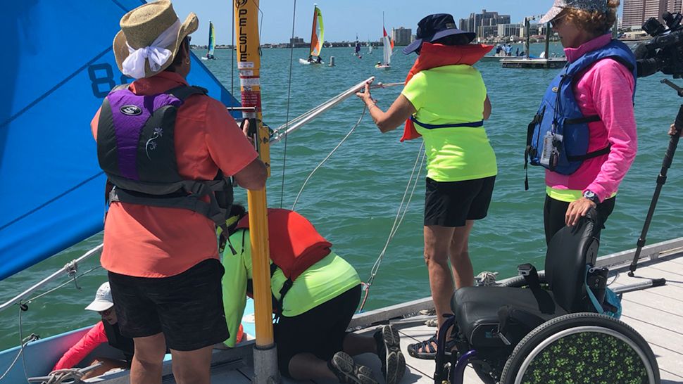 Volunteers with Sailability showed children with disabilities how to sail in access dinghies. (Angie Angers/Spectrum Bay News 9)