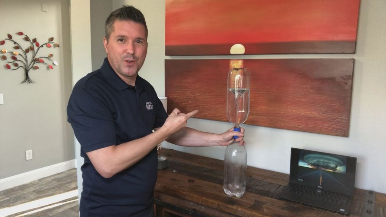 Spectrum News 13 Chief Meteorologist Bryan Karrick demonstrates how to make a "tornado in a bottle." (Spectrum News 13)