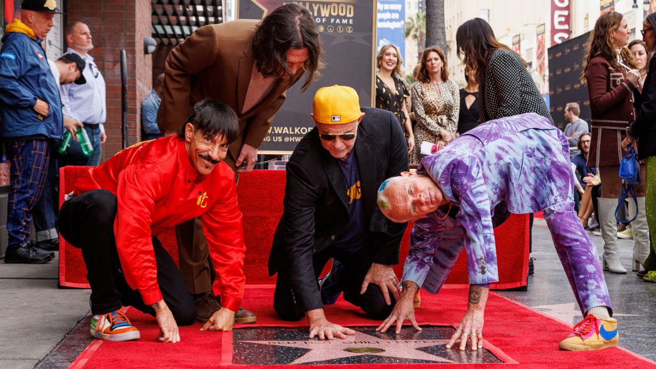 Anthony Kiedis, from left, John Frusciante, Chad Smith and Flea, of Red Hot Chili Peppers, appear at the unveiling of their star on the Hollywood Walk of Fame on Thursday, March 31, 2022, in Los Angeles. (Photo by Willy Sanjuan/Invision/AP)