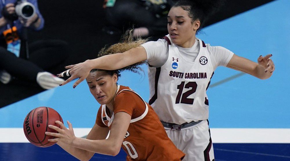 Texas guard Celeste Taylor (0) is pressured by South Carolina guard Brea Beal (12) during the first half of a college basketball game in the Elite Eight round of the women's NCAA tournament at the Alamodome in San Antonio, Tuesday, March 30, 2021. (AP Photo/Eric Gay)