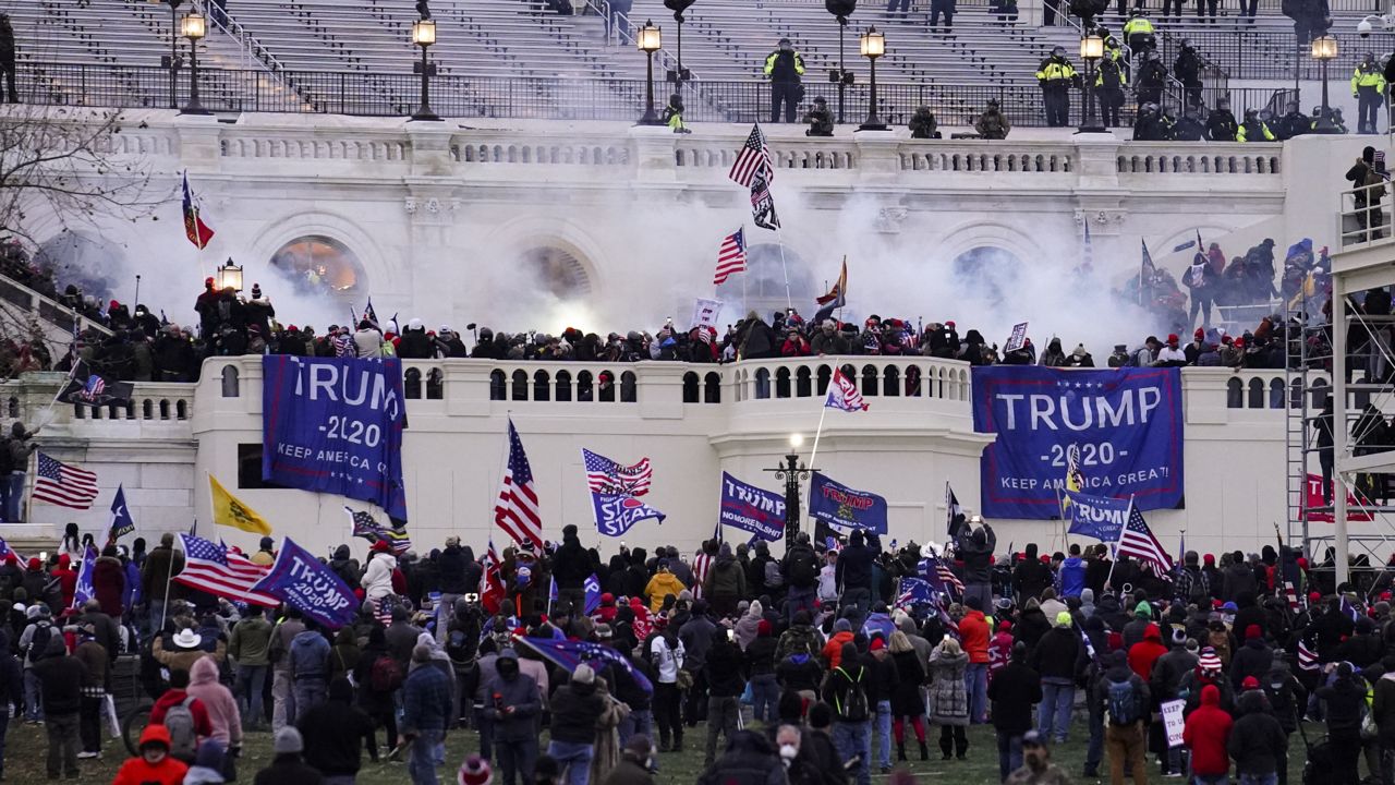 Violent protesters, loyal to President Donald Trump, storm the Capitol in Washington on Jan. 6, 2021. (AP Photo/John Minchillo)