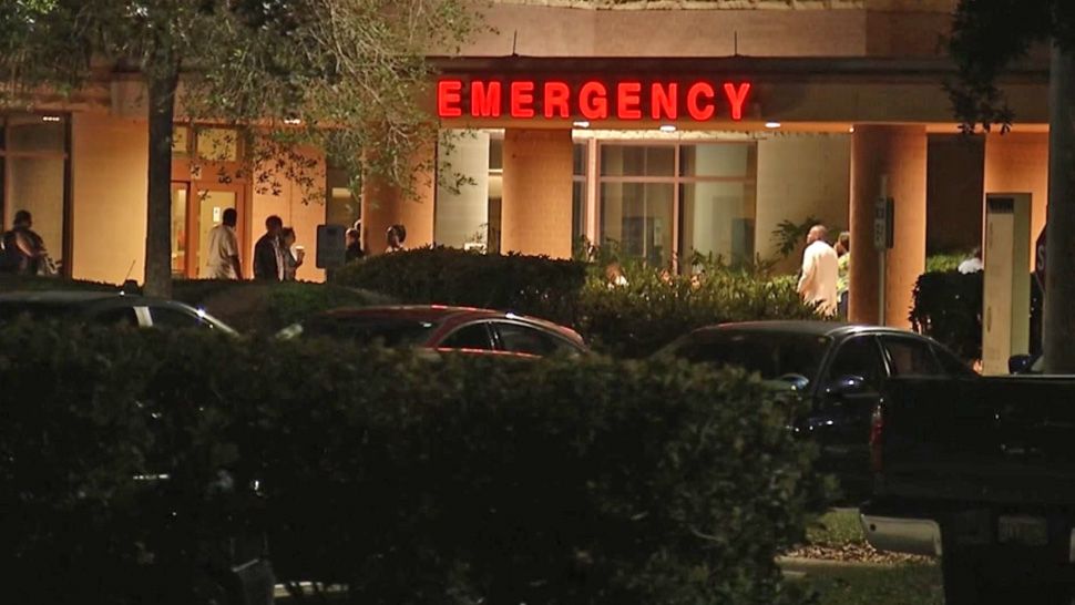 A crowd gathers outside Parrish Medical Center in Titusville after the hospital was placed on lockdown Sunday night. Two shooting victims were brought there. (Will Claggett/Spectrum News 13)