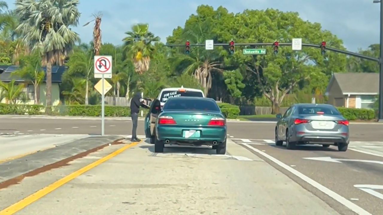 An individual approaches a vehicle during a what investigators are calling a carjacking Thursday in Winter Springs. (Seminole County Sheriff’s Office)