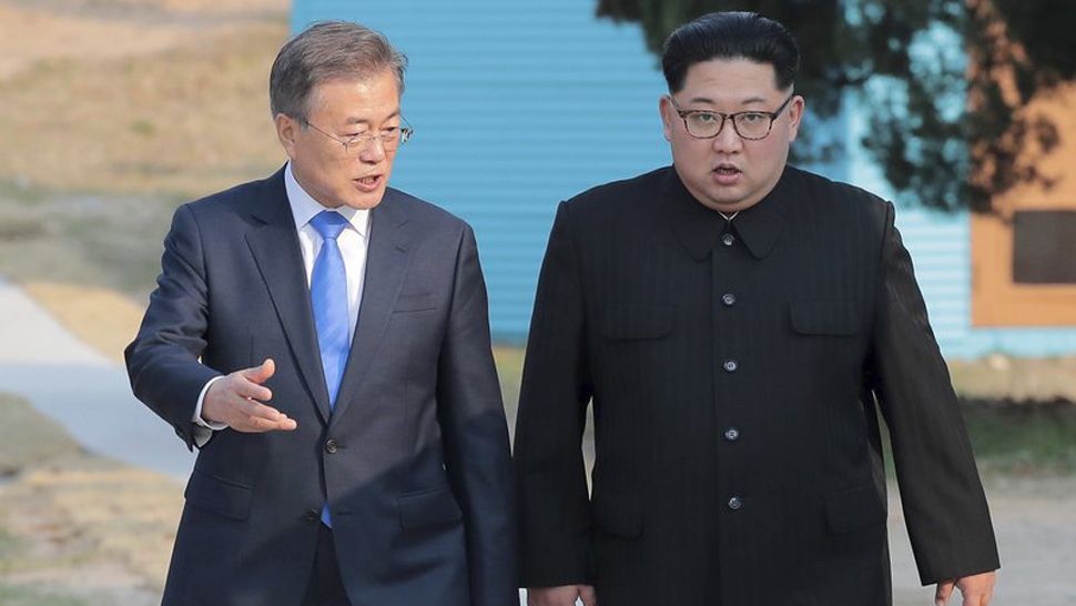 South Korean President Moon Jae-in, left, and North Korean Leader Kim Jong Un talk at the border village of Panmunjom in the Demilitarized Zone, South Korea, Friday, April 27, 2018. (Korea Summit Press Pool via AP)