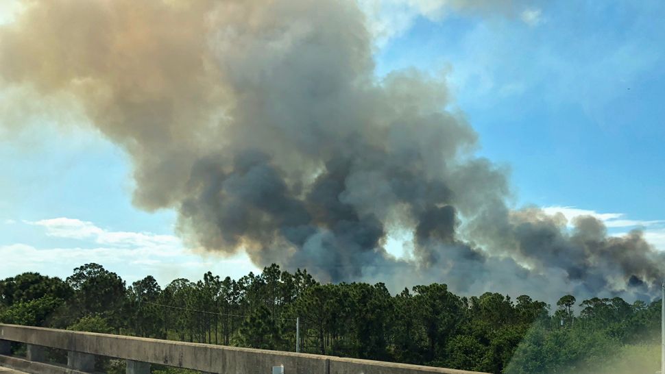 Submitted via the Spectrum News 13 app: Fire from the overpass at Micco Road and Interstate 95. (Rachel M., viewer)