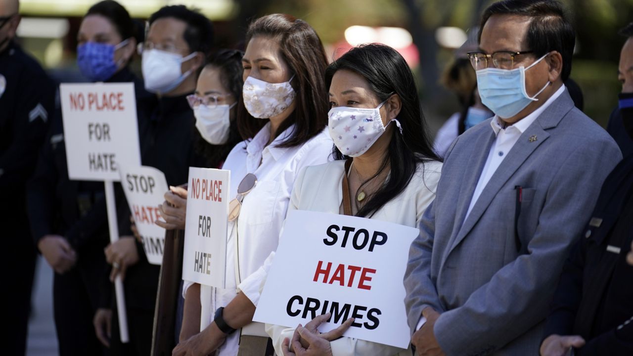 Demonstrators holds signs during a press conference calling to a halt on violence against Asian Americans in Los Angeles on March 22, 2021. (AP Photo/Marcio Jose Sanchez)