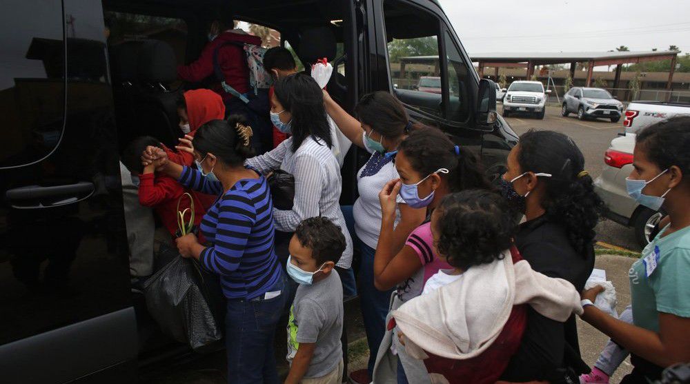 Migrants board a van at Our Lady of Guadalupe Catholic Church in McAllen, Texas, on Palm Sunday, March 28, 2021. (AP Photo/Dario Lopez-Mills)