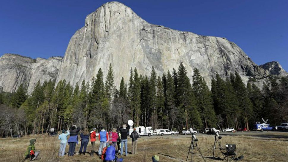 FILE - In this Jan. 14, 2015, file photo, spectators gaze at El Capitan for a glimpse of climbers Timmy Caldwell and Kevin Jorgeson, as seen from the valley floor in Yosemite National Park, Calif. The Interior Department is backing down from a plan to impose steep fee increases at popular national parks after widespread opposition from elected officials and the public. (AP Photo/Ben Margot, File)