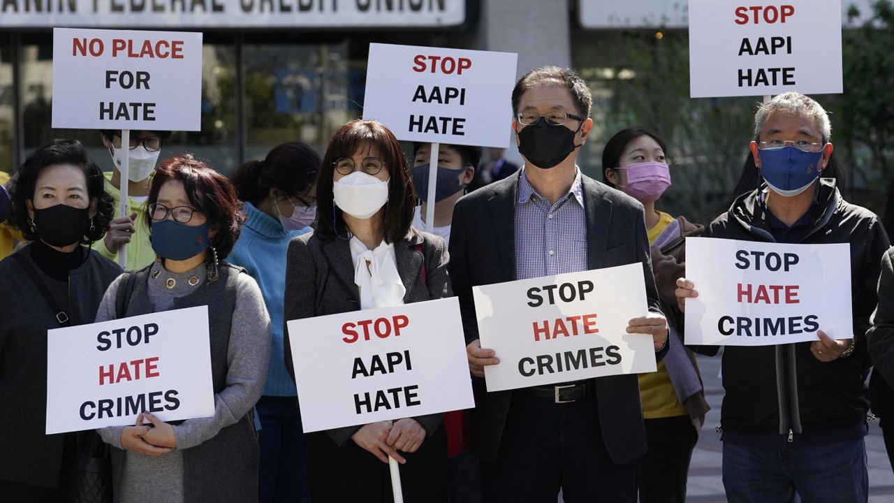 Demonstrators holds signs during a press conference calling to a halt on violence against Asian Americans Monday, March 22, 2021, in Los Angeles. (AP Photo/Marcio Jose Sanchez)