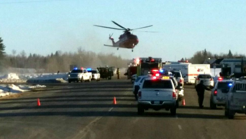 This image provided by 650 CKOM/980 CJME shows emergency crews responding to the scene where a bus carrying a junior hockey team to a playoff game was struck by a semi Friday, April 6, 2018, north of Tisdale, Saskatchewan, Canada. Police say there were 28 people, including the driver, on board the bus of the Humboldt Broncos team when the crash occurred around 5 p.m. Friday on Highway 35. (650 CKOM/980 CJME via AP)
