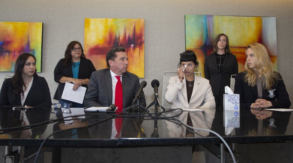 Ashley Solis, second right, the first woman to file sexual assault claims against Houston Texans quarterback Deshaun Watson, gives a statement during a news conference with attorney Tony Buzbee and his legal team, Tuesday, April 6, 2021, in Houston. (Yi-Chin Lee/Houston Chronicle via AP)