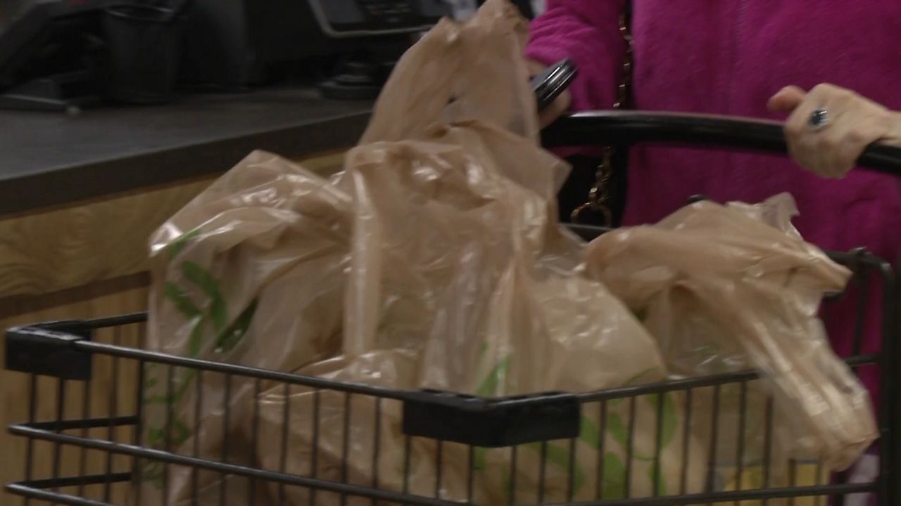 shopping cart full of plastic bags