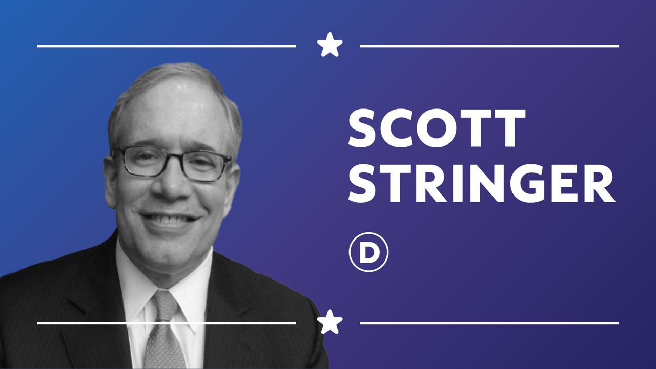 Scott Stringer, wearing a black suit jacket, a white dress shirt, black, square-framed glasses, and a scarlet tie with white dots, at NAN.