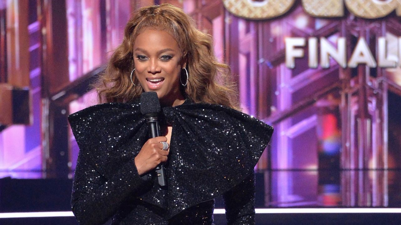 This mage released by ABC shows host Tyra Banks during last season's finale of "Dancing with the Stars." The competition series, which debuted on the broadcast network in 2005, will be on Disney+ starting this fall in the U.S. and Canada, the company announced Friday. (Eric McCandless/ABC via AP)