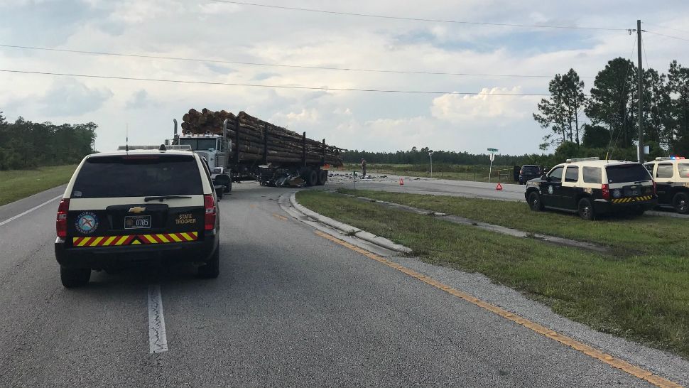 Troopers investigate a deadly crash on State Road 520 on Monday in which a logging truck turned into the path of Buick that became wedged underneath, the Florida Highway Patrol said. (Courtesy of FHP)