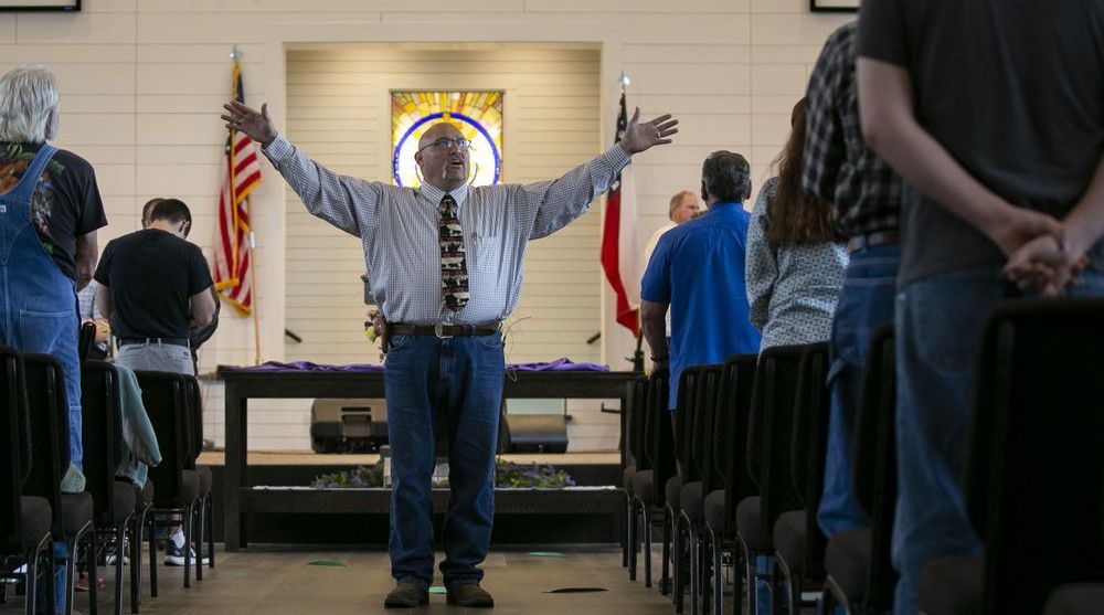 In this Sunday, April 5, 2020 photo, Pastor Frank Pomeroy preaches during a Sunday morning service at First Baptist Church in Sutherland Springs, Texas. (Josie Norris/The San Antonio Express-News via AP)