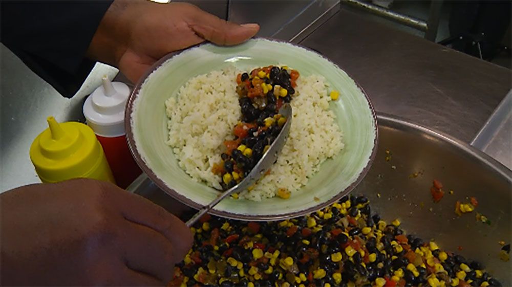 Chef creates a 'canal' within the jasmine rice to put the salsa before topping with salmon. 