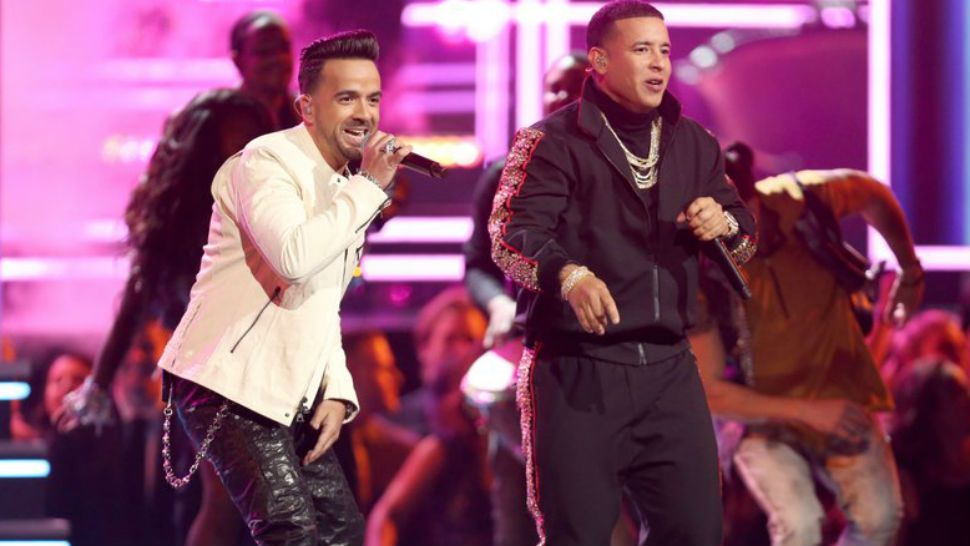 FILE - In this Jan. 28, 2018 file photo, Luis Fonsi, left, and Daddy Yankee perform “Despacito” at the 60th annual Grammy Awards in New York. “Despacito” and other popular music videos were the target of a security breach on the video sharing service Vevo. The cover image of the Luis Fonsi/Daddy Yankee hit was replaced by an image of masked people pointing guns. Clips by Taylor Swift, Drake, Selena Gomez and Shakira also were affected. A YouTube spokesperson says the company worked with its partner to disable access after seeing “unusual upload activity” on some Vevo channels. (Photo by Matt Sayles/Invision/AP, File)