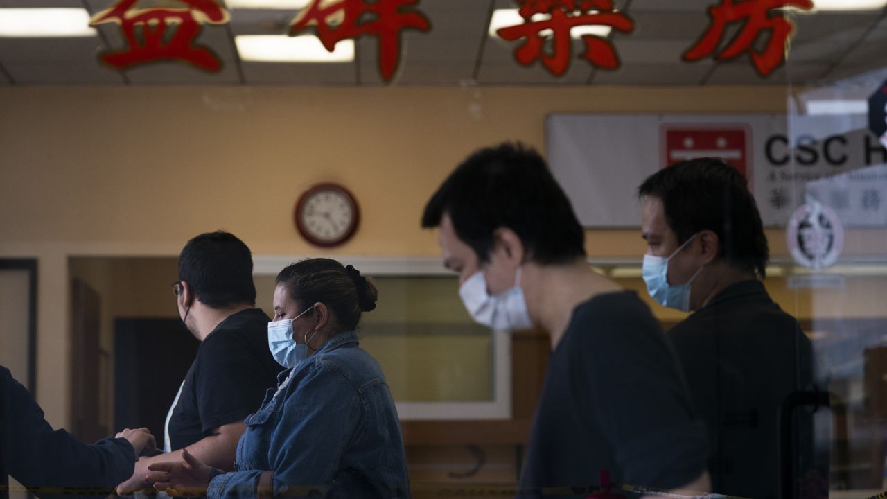 People wait in line to get the Moderna vaccine at a vaccination center in the Chinatown neighborhood of Los Angeles, Monday, April 12, 2021. (AP Photo/Jae C. Hong)