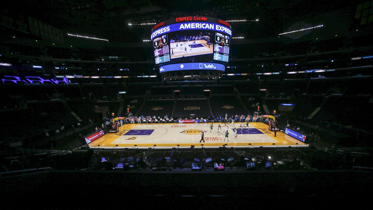 The Los Angeles Lakers play the Dallas Mavericks in an empty Staples Center amid the coronavirus pandemic, during an NBA basketball game Friday, Dec. 25, 2020, in Los Angeles. (AP Photo/Ringo H.W. Chiu)
