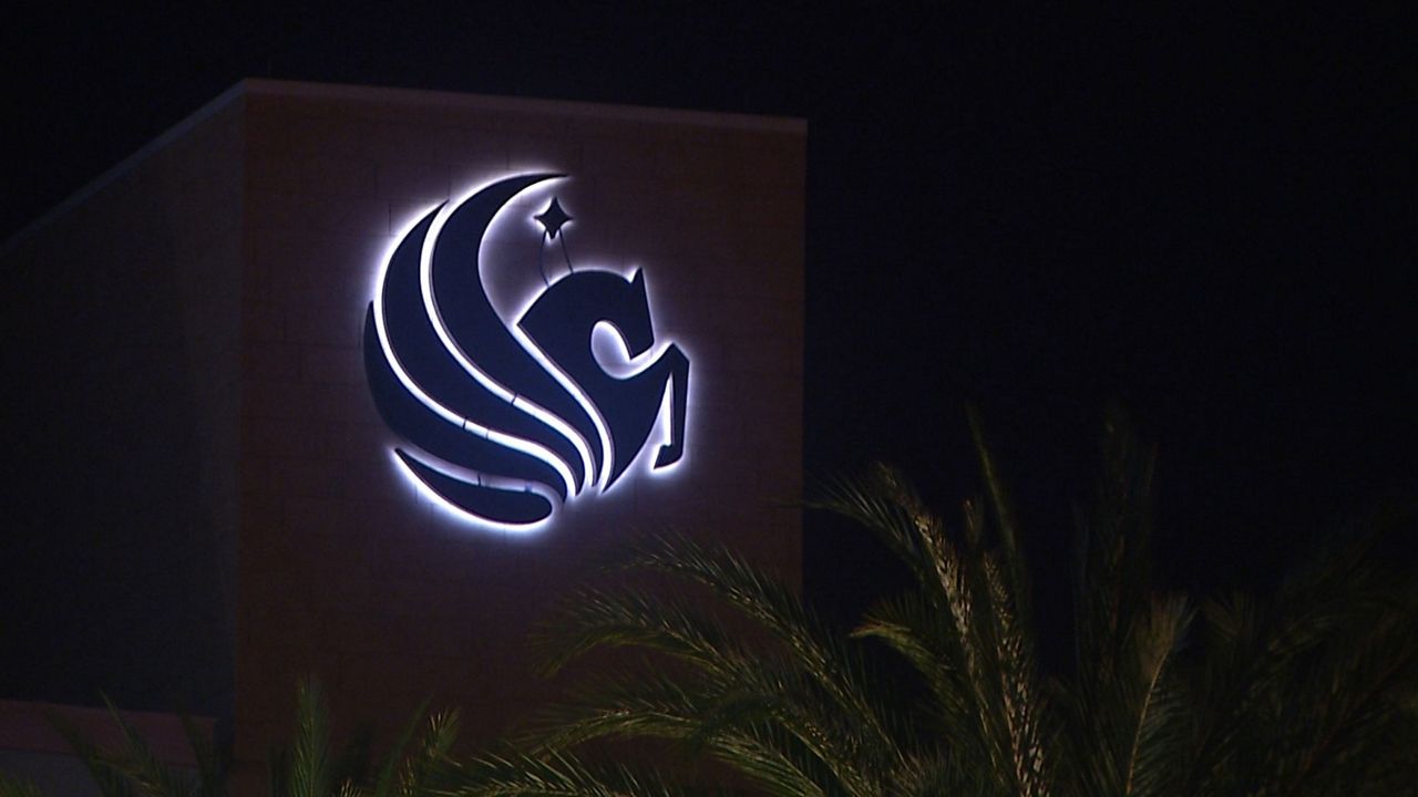 UCF logo lit up at night.