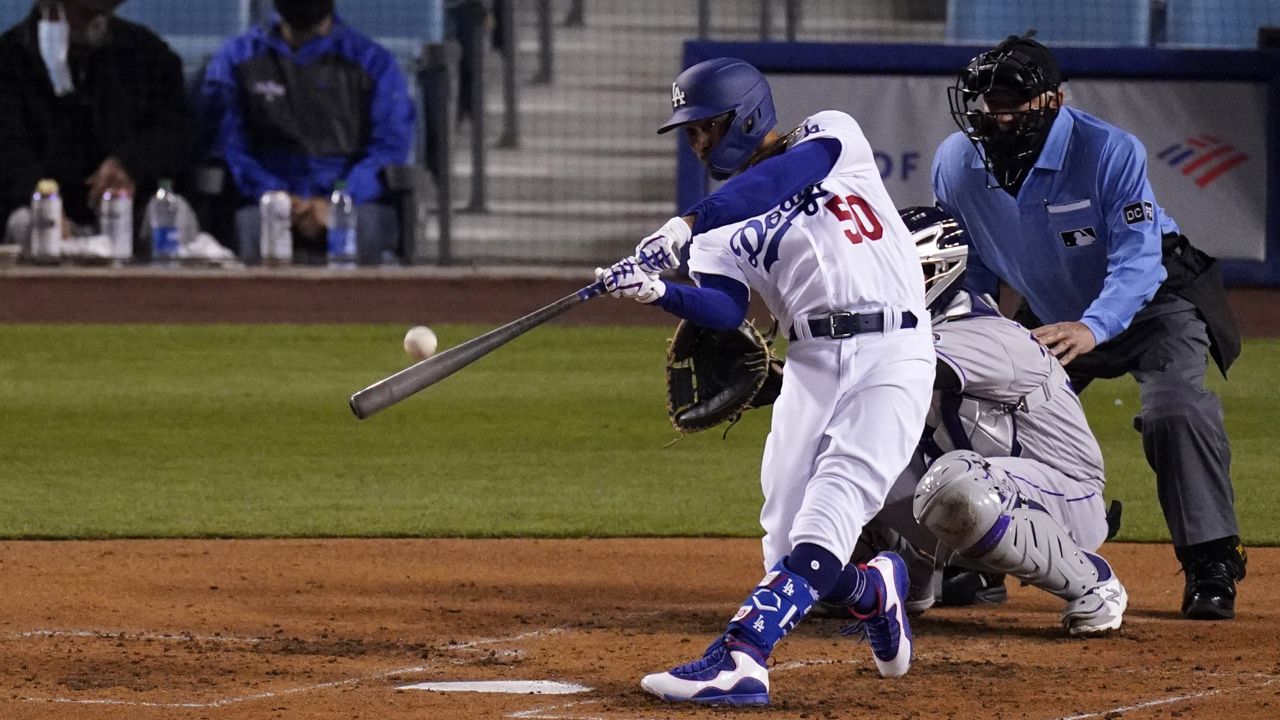 Betts, Bauer star for new fans as Dodgers crush Rockies 7-0