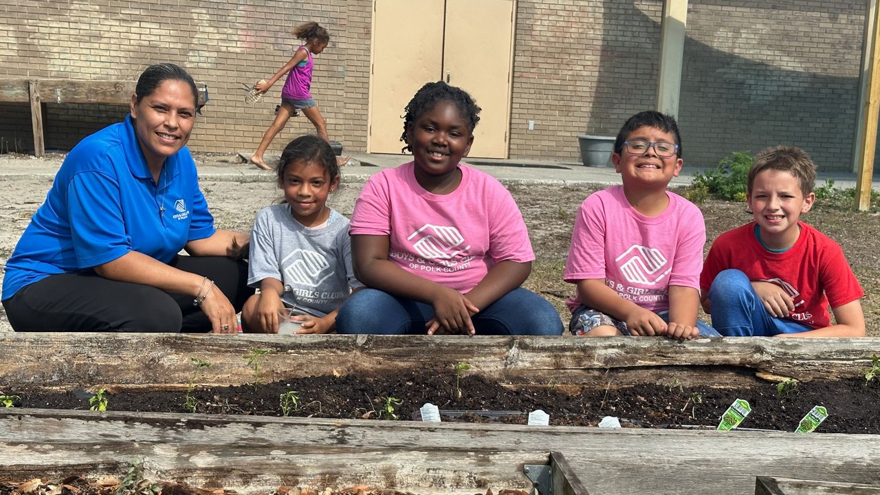 Boys and Girls club staff with students, who will learn how to plant their own food. (Spectrum News)