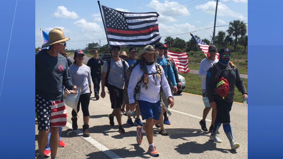 Former Orange County firefighter Tom "Bull" Hill (center) is walking across the state of Florida to raise awareness of the increased risk of cancer in his profession. (Jonathan Shaban, staff)