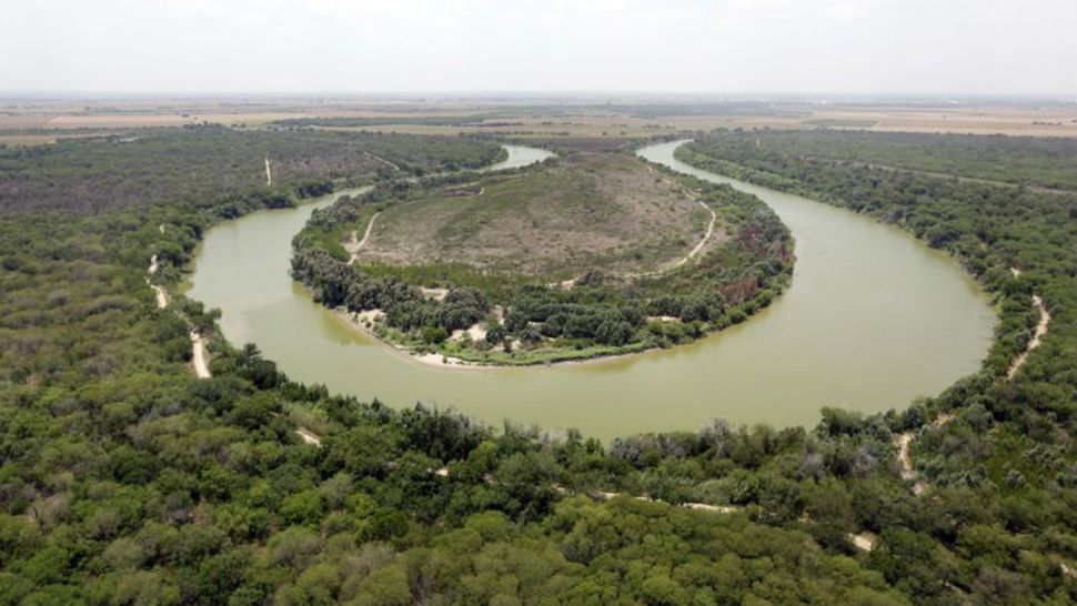 FILE - In this July 24, 2014 photo a bend in the Rio Grande is viewed from a Texas Department of Public Safety helicopter on patrol over in mission, Texas. As hundreds of national Guard troops deploy to the U.S.-Mexico border, residents of Texas' southernmost border region are fearful of the impact President Donald Trump's border wall will have. The troops patrolling the Rio Grande will eventually withdraw, but a wall could change the river forever. (AP Photo/Eric Gray, Pool, File)