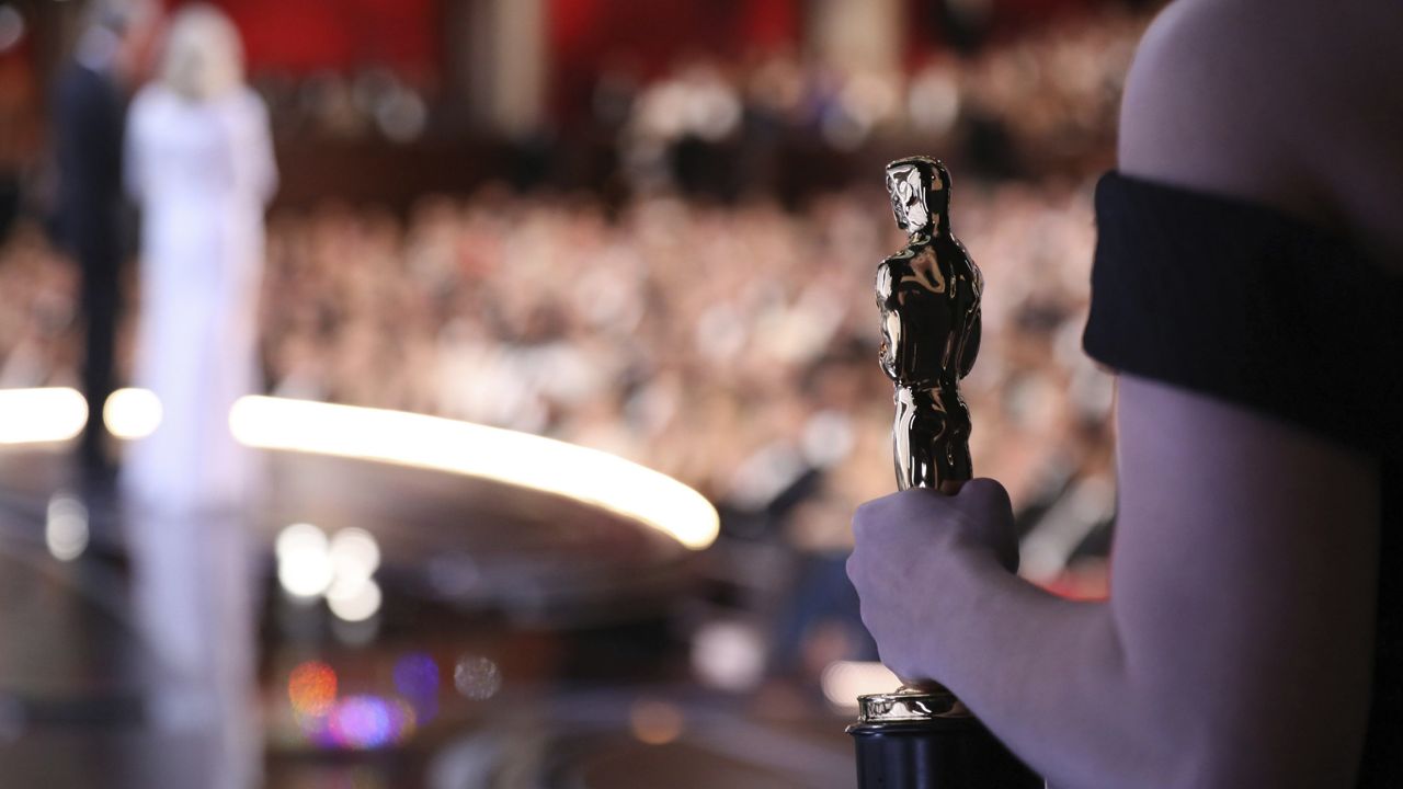 One of the best picture Oscar statuettes appears off stage as Warren Beatty and Faye Dunaway announce the best picture winner at the Oscars on Sunday, Feb. 26, 2017, at the Dolby Theatre in Los Angeles. (Photo by Matt Sayles/Invision/AP)