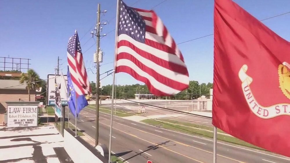 The city of Jacksonville says these flags will stay on the roof of Jaguar Power Sports, after a city inspector cited the business for them. (CNN)