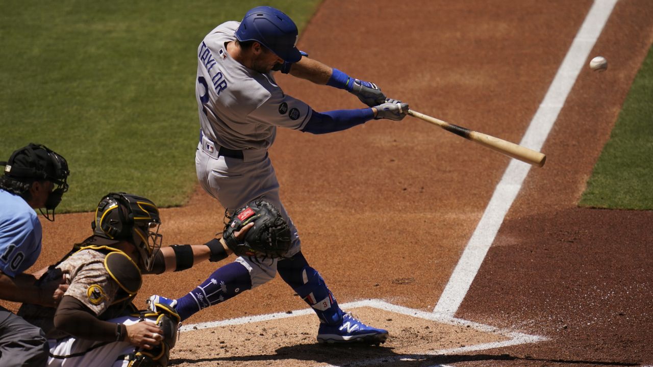 Los Angeles Dodgers' Chris Taylor hits a two-run home run during the second inning of a baseball game against the San Diego Padres, Sunday, April 18, 2021, in San Diego. (AP Photo/Gregory Bull)