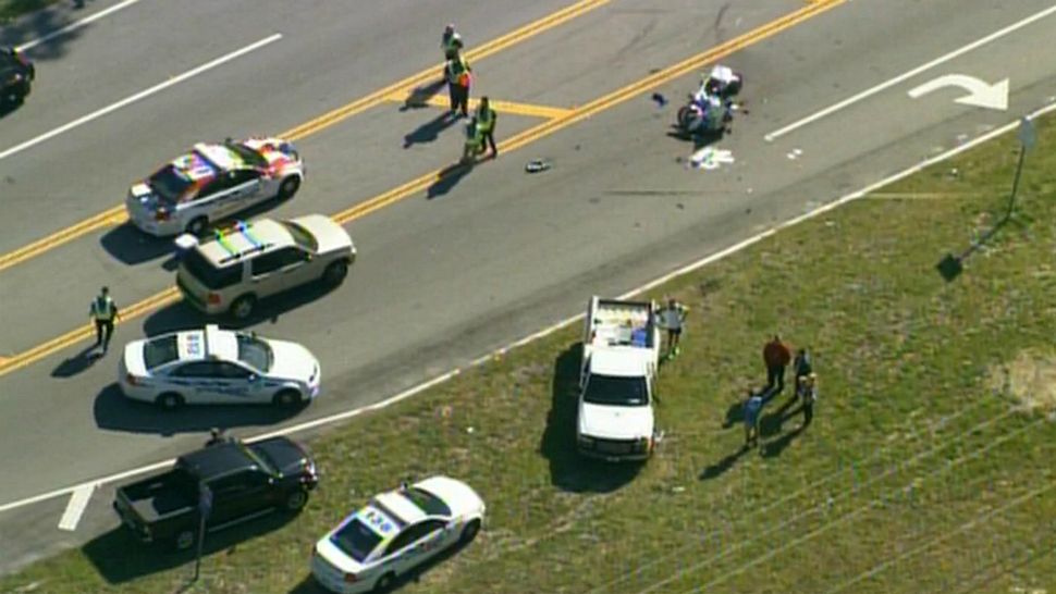 Police investigate a crash involving an Ormond Beach motorcycle officer and a white pickup truck on Hand Avenue on Wednesday. (Sky 13)