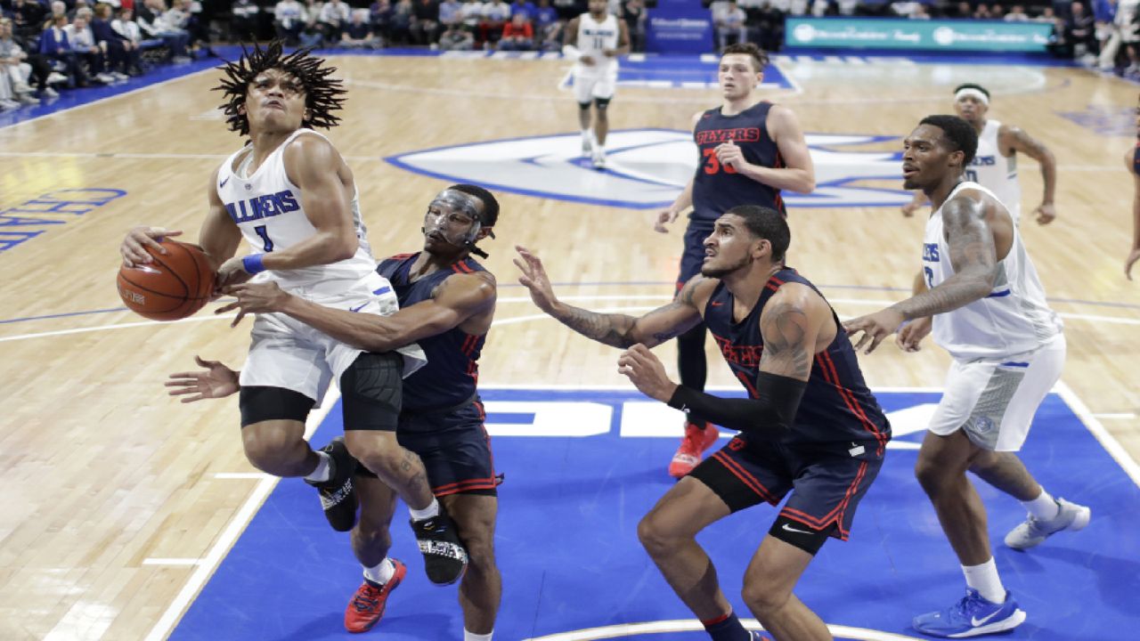 Saint Louis' Yuri Collins, left, heads to the basket as Dayton's Rodney Chatman, second from left, and Obi Toppin defend during the first half of an NCAA college basketball game Friday, Jan. 17, 2020, in St. Louis. (AP Photo/Jeff Roberson)